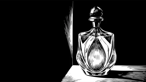  a minimalist glass perfume bottle with a golden cap