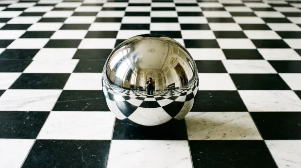 A perfectly reflective chrome (Chrome) mirror ball placed on a black and white checkerb… — Image generated by Nano Banana Pro Text-To-Image API